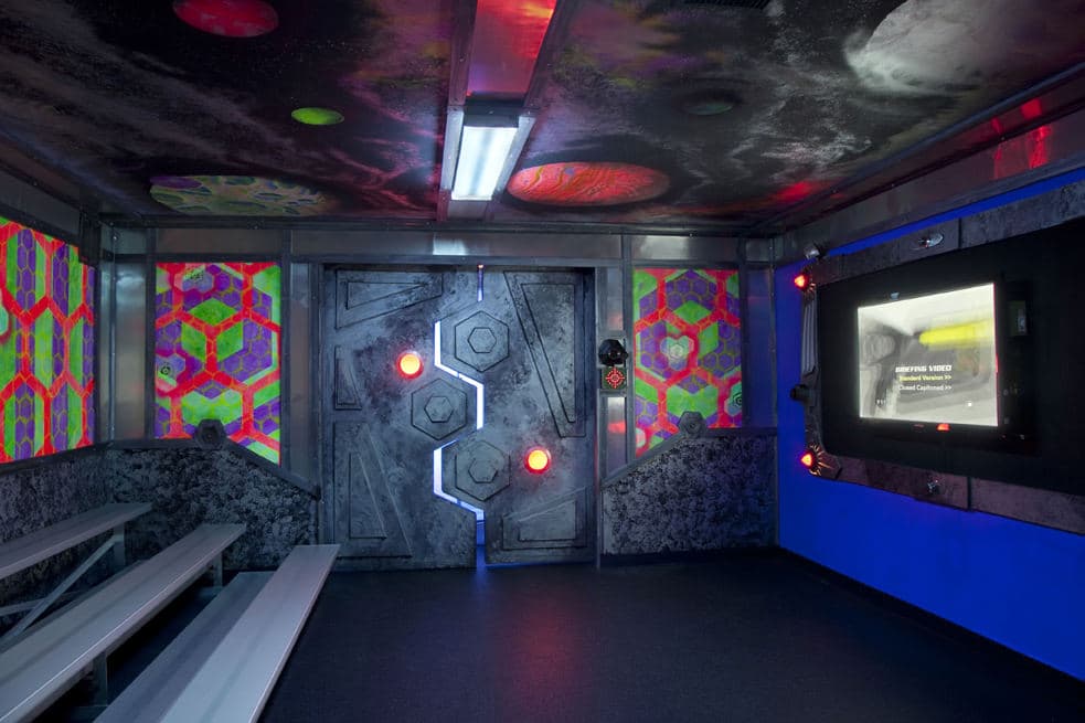 Immersive briefing room with honeycomb panels and briefing video screen