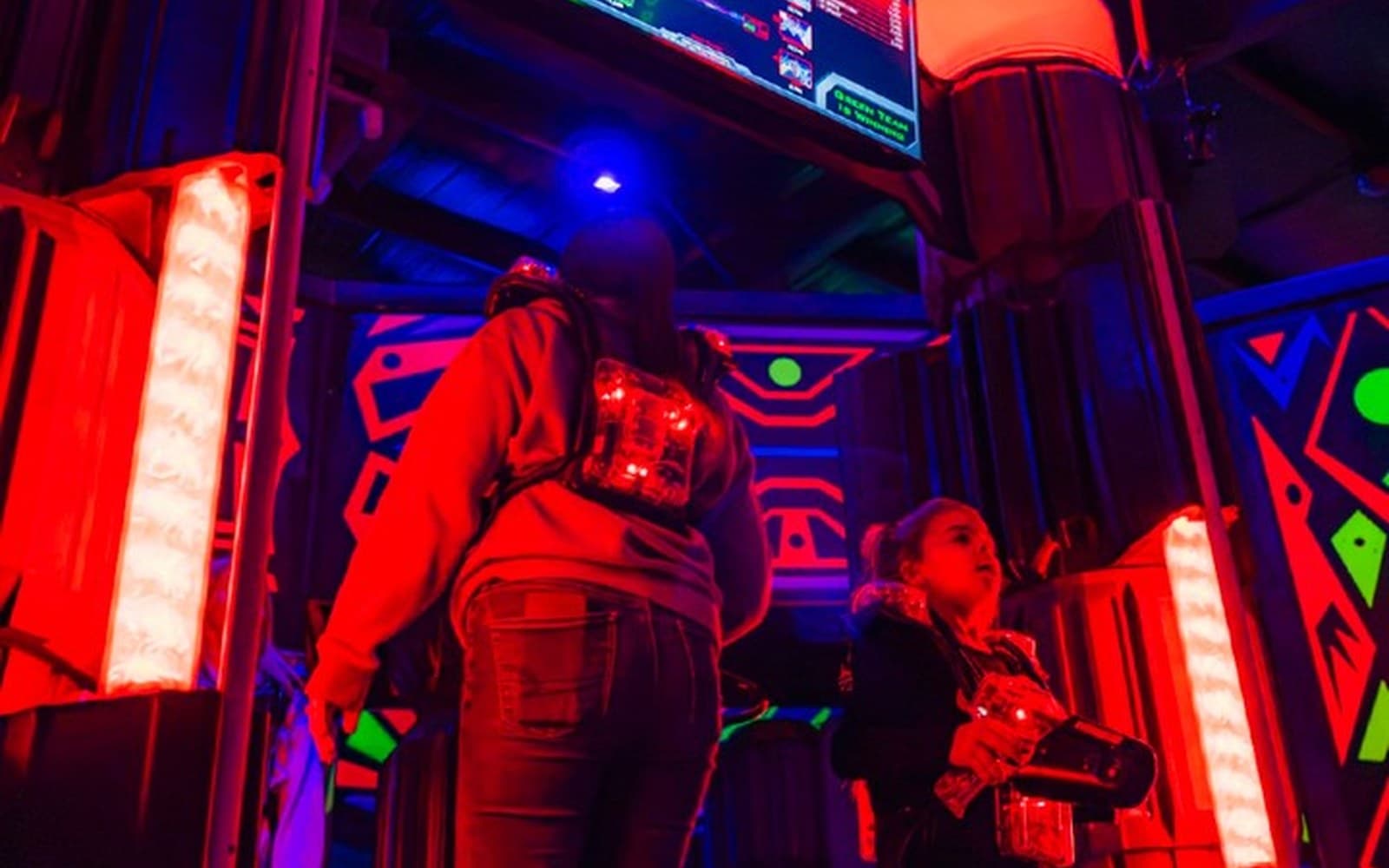 Players battling in the neon-lit laser tag arena
