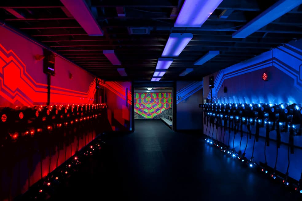 Red and blue laser tag vest racks ready for gear-up